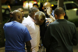 Worshippers embrace following a group prayer across the street from the Emanuel AME Church following a shooting Wednesday, June 17, 2015, in Charleston, S.C. (AP Photo/David Goldman)