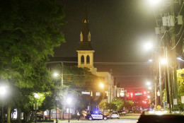 The steeple of Emanuel AME Church is visible as police close off a section of Calhoun Street early Thursday, June 18, 2015 following a shooting Wednesday night in Charleston, S.C. (AP Photo/David Goldman)