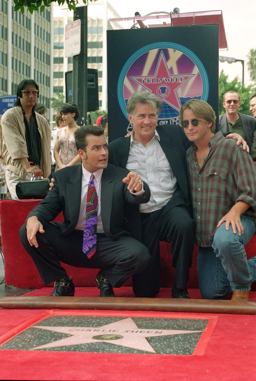 Actor Charlie Sheen, left, poses with his father, actor Martin Sheen, center, and brother, actor Emilio Estevez, after receiving his star on the Hollywood Walk of Fame in Los Angeles, Ca., on Sept. 23, 1994.  (AP Photo/Rhonda Birndorf)