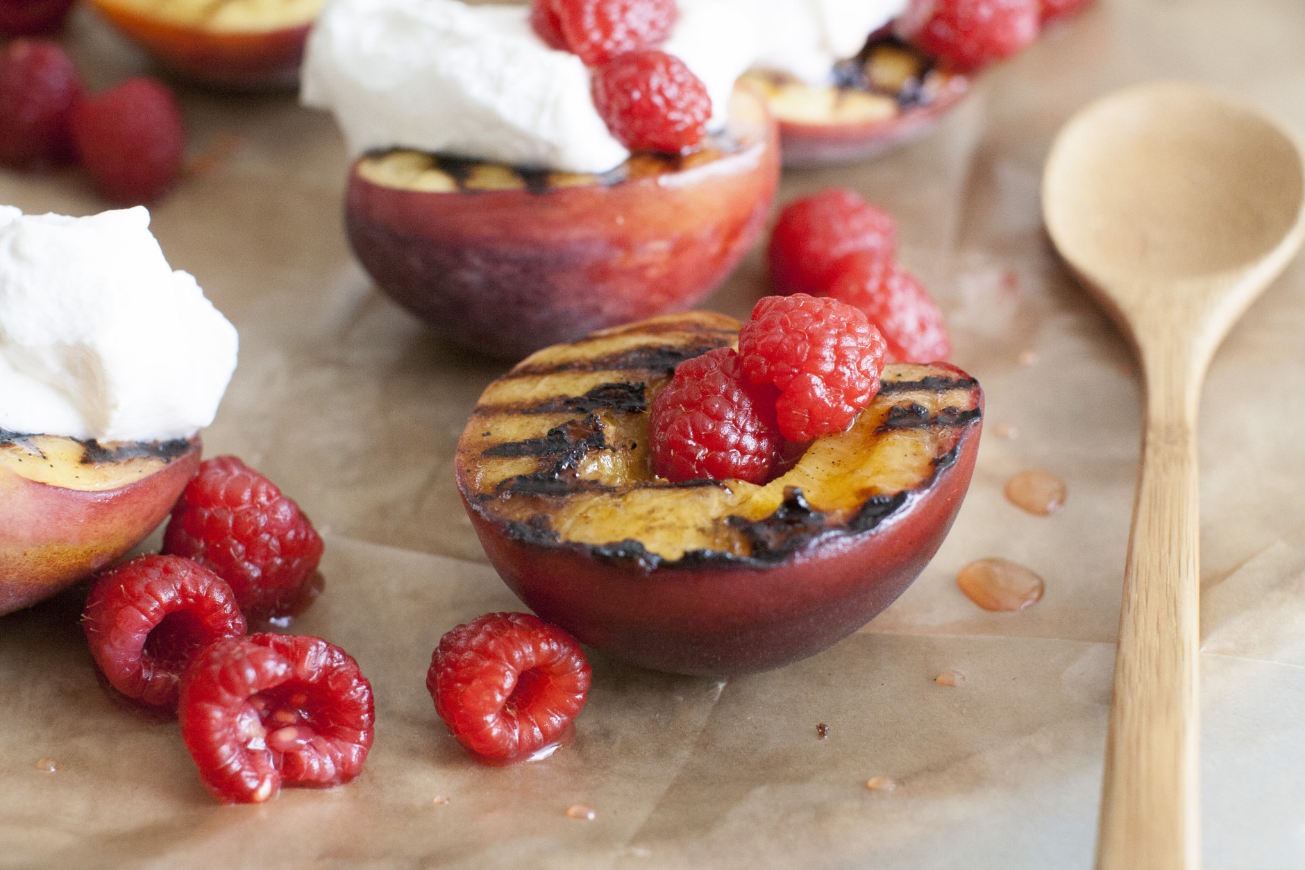 This June 2, 2014 photo shows grilled peaches, berries and cream in Concord, N.H. It is a grilled dessert that is simple and takes just minutes to cook and assemble. (AP Photo/Matthew Mead)