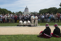 Spectators watch a 'blessing of the bridge' at the Smithsonian Folklife Festival on the Mall in Washington, Wednesday, June 24, 2015. Peru's artists, cultures and famous foods are being featured in the Smithsonian Folklife Festival this year on the National Mall as the South American nation aims to boost tourism and cultural exchange. (AP Photo/Molly Riley)