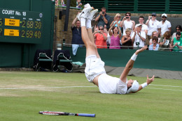 Isner dropped to the ground in jubilation after hitting the final winner, more than 11 hours of play after the match began. (AP Photo/Alastair Grant,Pool)