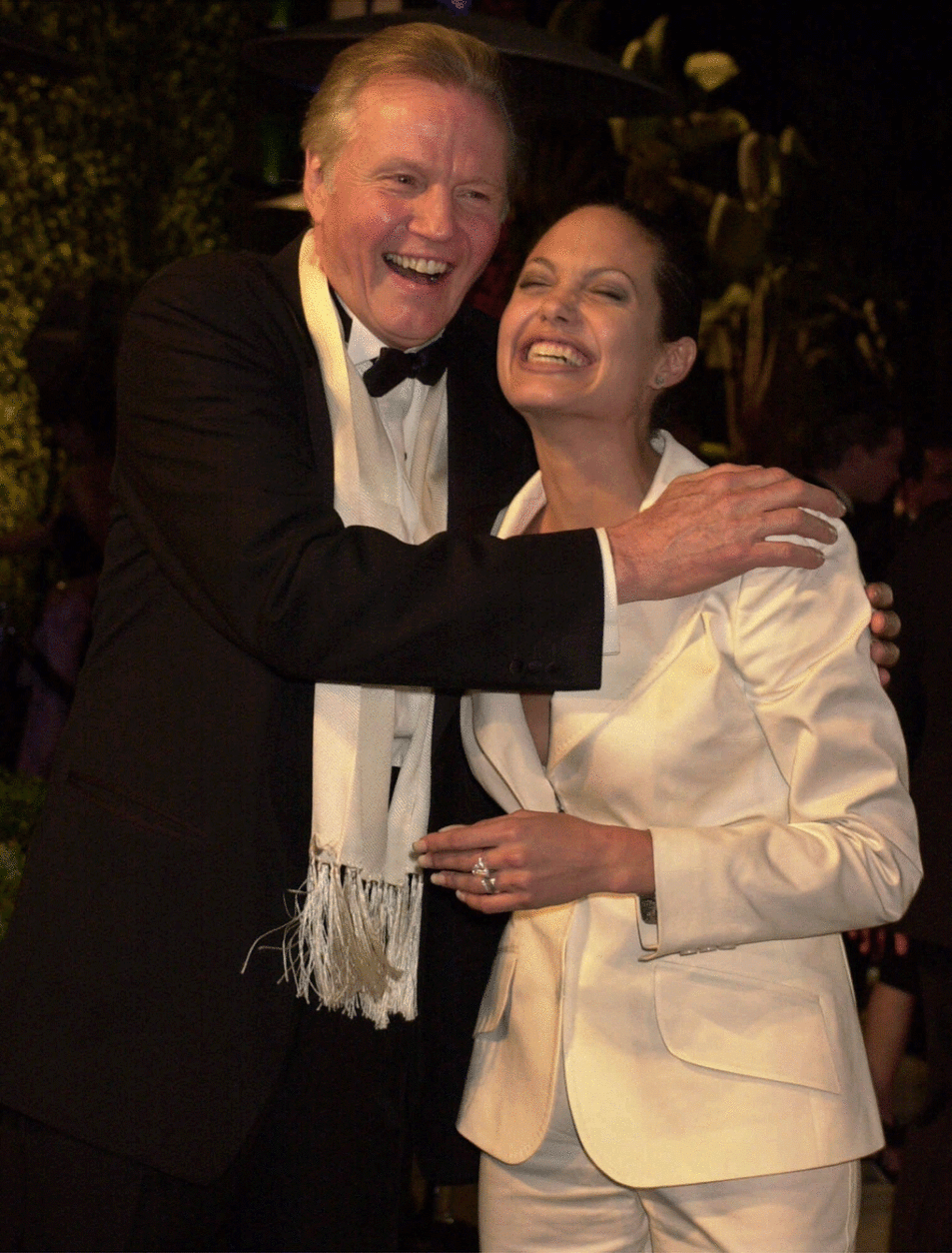 Jon Voight and his daughter Angelina Jolie laugh at the Vanity Fair Oscar party at Morton's in Hollywood on March 25, 2001. (AP Photo/Laura Rauch)