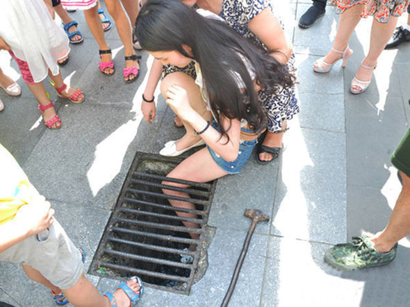 Down the drain: Girl walking and texting gets stuck