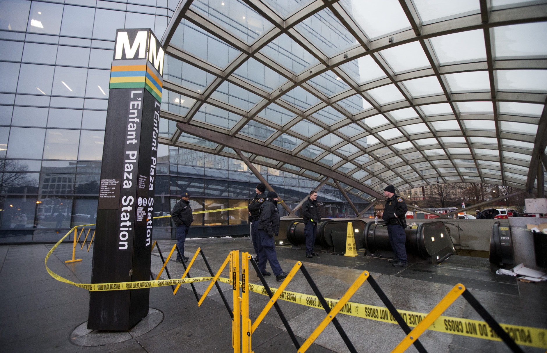Metro Transit Police officers, secure the entrance to LEnfant Plaza Station in Washington, Monday, Jan. 12, 2015. Metro officials say one of the busiest stations in downtown Washington has been evacuated because of smoke. (AP Photo/Manuel Balce Ceneta)