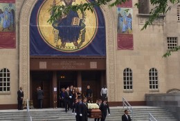Katerina and Abigail Savopoulos follow their younger brother's casket out of St. Sophia Greek Orthodox Cathedral. (WTOP/Megan Cloherty)