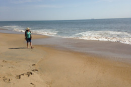 A woman walks along Rehoboth Beach in this WTOP file photo. (WTOP/Michelle Basch)