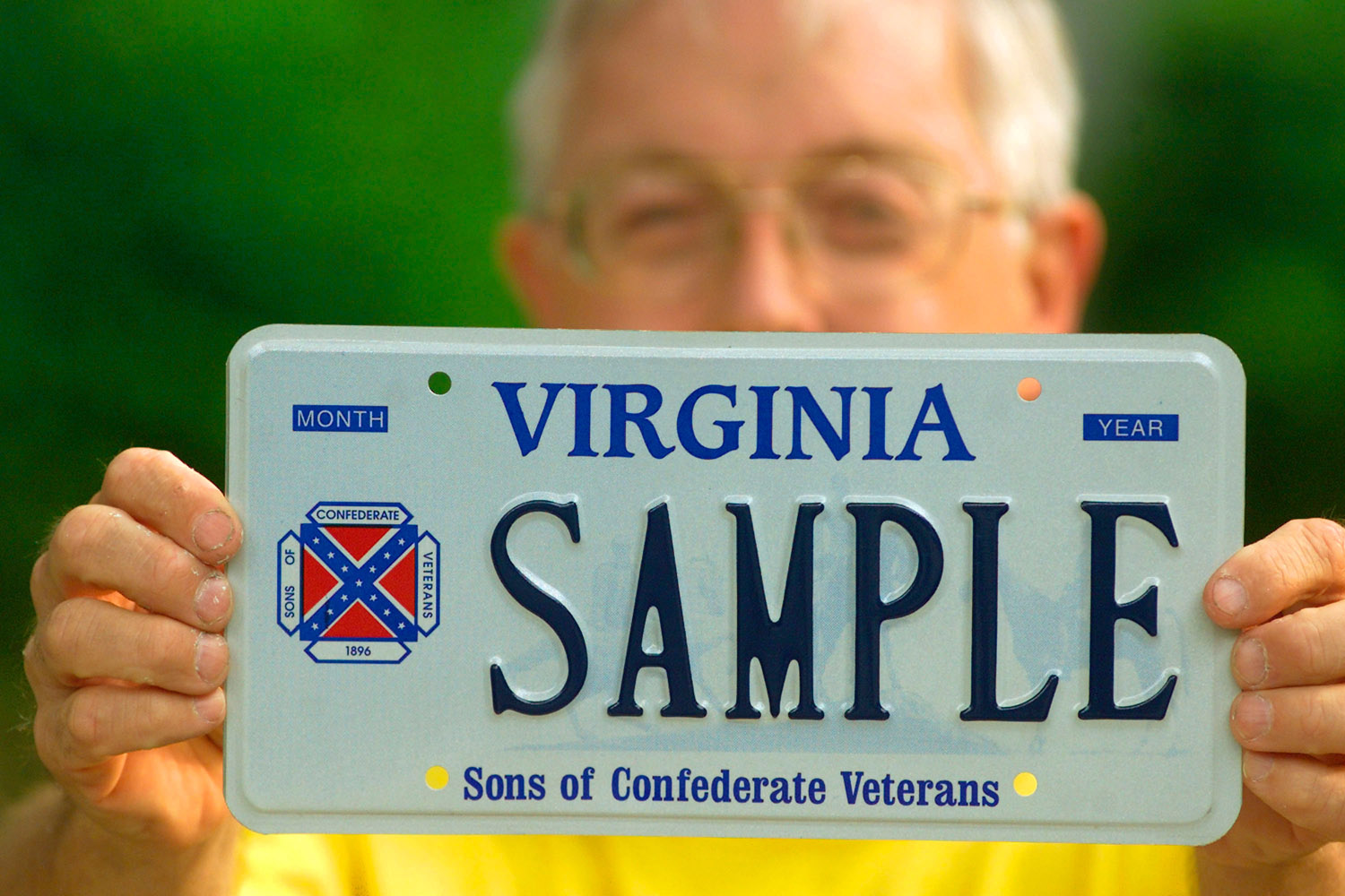 Brag Bowling, First Lieutenant Commander Of The Sons Of Confederate Veterans Virginia Division, Holds A Sample Virginia Licence Plate Containing His Organization's Logo, Which Incorporates The Confederate Battle Flag, May 8, 2002 In Richmond, Va. A Federal Appeals Court Ruled Last Week That Virginia Cannot Block The Group From Displaying The Logo On Speciality License Plates. The 4Th U. S. Circuit Court Of Appeals Ruled Against The State's Claim That The Licence Plates Constitute Public Speech And That The State Had The Right To Regulate Which Groups And Designs Are Allowed On Plates That Represent Virginia. Bowling Said His Group Hopes To Have Their Plates By Mid-Summer.  (Photo By Wayne Scarberry/Getty Images)