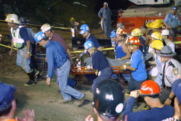 Pennsylvania Gov. Mark Schweiker, left, helps carry out the last of the trapped miners at the Quecreek Mine  in Somerset, Pa., Sunday July 28, 2002.    (AP Photo/Steve Helber/POOL)