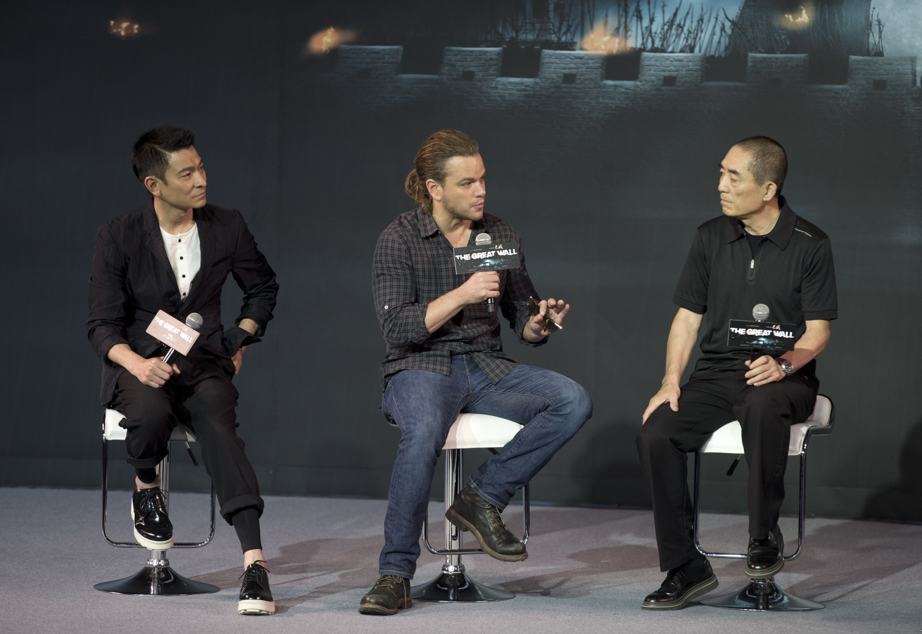 Actor Matt Damon, center, speaks next to Hong Kong movie star Andy Lau, left, and director Zhang Yimou, right, during a press conference of their latest movie The Great Wall held at a hotel in Beijing, China, Thursday, July 2, 2015. Zhang Yimou says that the Sino-U.S. fantasy adventure movie set around the building of the Great Wall and starring Matt Damon combines a Chinese land and story with Hollywood monsters.  (AP Photo/Andy Wong)
