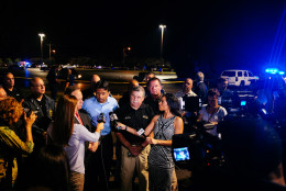 Louisiana Gov. Bobby Jindal, center, speaks with the media following a deadly shooting at the Grand Theatre in Lafayette, La., Thursday, July 23, 2015. (AP Photo/Denny Culbert)