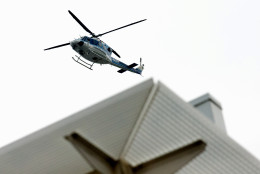 A U.S. Park Police helicopter hovers overhead at the Washington Navy Yard campus in Washington, Thursday, July 2, 2015. A lockdown was underway Thursday morning across the Washington Navy Yard campus after reports of shots fired, but a senior law enforcement official said those reports had not been confirmed.   (AP Photo/Andrew Harnik)