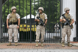 Soldiers guard at the Navy Barracks in Washington, Thursday, July 2, 2015. A lockdown is underway on the entire Washington Navy Yard campus after a report of shots fired. A federal official says there were reports of shots fired Thursday morning in the same building where a gunman killed a dozen workers in a rampage two years ago. The official, speaking on condition of anonymity because the official wasn't authorized to discuss details publicly, says there are no reports of injuries nor has a shooter been identified.  (AP Photo/Jacquelyn Martin)