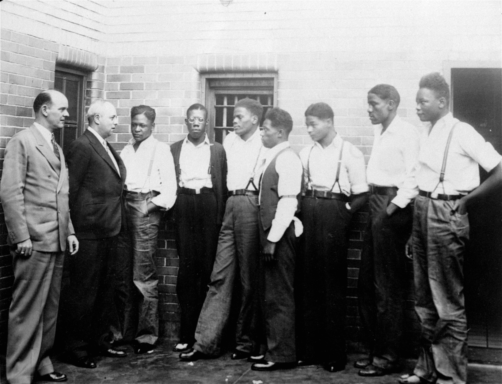 Just after he asked the Governor of Alabama to pardon the nine youths held in the Scottsboro case, Samuel Leibowitz, New York attorney, conferred with seven of the defendants, May 1, 1935, at the Scottsboro jail.  Left to right are:  Deputy Sheriff Charles McComb, Leibowitz, and the defendants, Roy Wright, Olen Montgomery, Ozie Powell, Willie Robertson, Eugene Williams, Charlie Weems, and Andy Wright.  The youths were charged with an attack on two white women on March 25, 1931.  (AP Photo)