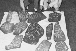 On this date in 1587, an English colony fated to vanish under mysterious circumstances was established on Roanoke Island off North Carolina. In this image, Dr. H.J. Pearce Jr., left, and his father, Dr. H.J. Pearce, are seen as they displayed 13 stones found near Greenville, S.C., which they believed would bring about a solution to the mystery surrounding the fate of Sir Walter Raleigh’s “Lost Colony.” (AP Photo)