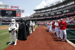 Star Wars characters in costume stand with the Washington Nationals after the national anthem on Star Wars day, before a baseball game against the Los Angeles Dodgers at Nationals Park, Sunday, July 19, 2015, in Washington. (AP Photo/Alex Brandon)