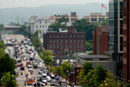 A large police presence is seen looking down M St. in Southeast Washington, Thursday, July 2, 2015, near the Washington Navy Yard campus. A lockdown was underway Thursday morning across the Washington Navy Yard campus after reports of shots fired, but a senior law enforcement official said those reports had not been confirmed.   (AP Photo/Andrew Harnik)