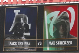 The scoreboard dispays the pitching matchup between Los Angeles Dodgers starting pitcher Zack Greinke and Washington Nationals starting pitcher Max Scherzer on Star Wars Day before a baseball game at Nationals Park, Sunday, July 19, 2015, in Washington. (AP Photo/Alex Brandon)