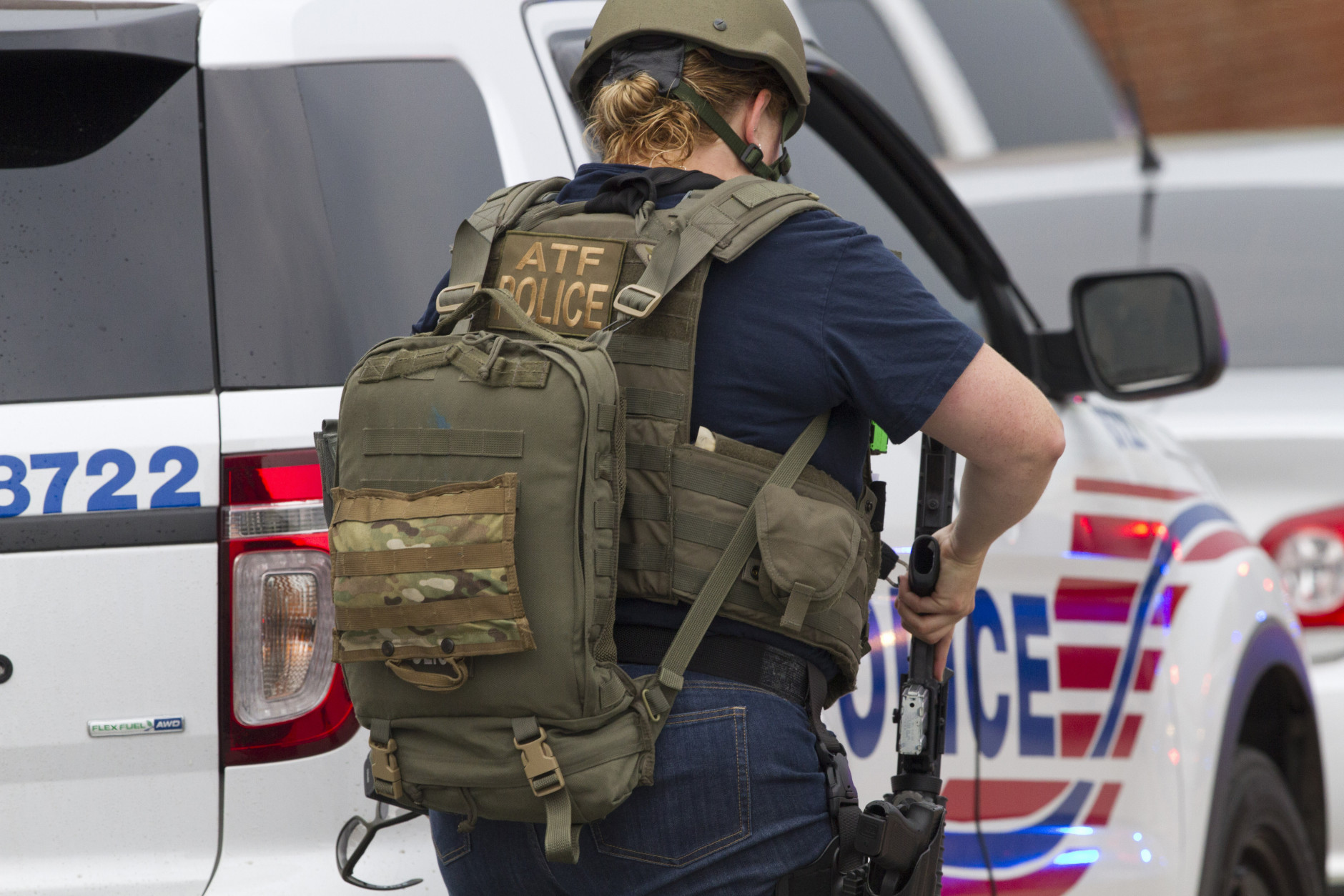 An ATF (Bureau of Alcohol, Tobacco, Firearms and Explosives) police officer walks toward the Navy Yard in Washington, Thursday, July 2, 2015. The Washington Navy Yard was on lockdown Thursday morning after reports of gunshots, but a senior federal law enforcement official says there has been no confirmed report of any shooting.   (AP Photo/Jacquelyn Martin)
