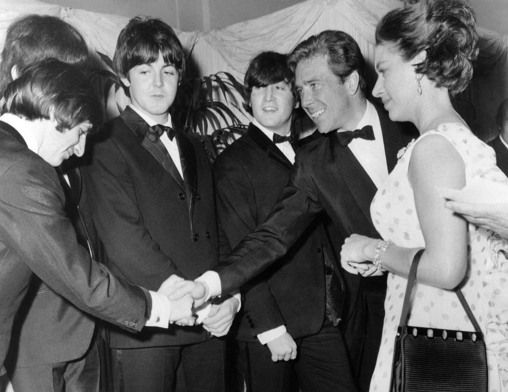 On this date in 1965, The Beatles' second feature film, "Help!," had its world premiere in London. Here, Britain's Lord Snowdon, Anthony Armstrong Jones, shakes hands with Ringo Starr when he and his wife met the Beatles before the world charity premiere  of "Help!"  at the London Pavilion, in London, England, on July 29, 1965. Left to right; Ringo Starr, George Harrison, Paul McCartney, John Lennon, Lord Snowdon and Princess Margaret.  (AP Photo)