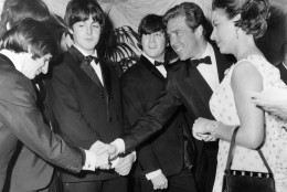 On this date in 1965, The Beatles' second feature film, "Help!," had its world premiere in London. Here, Britain's Lord Snowdon, Anthony Armstrong Jones, shakes hands with Ringo Starr when he and his wife met the Beatles before the world charity premiere  of "Help!"  at the London Pavilion, in London, England, on July 29, 1965. Left to right; Ringo Starr, George Harrison, Paul McCartney, John Lennon, Lord Snowdon and Princess Margaret.  (AP Photo)