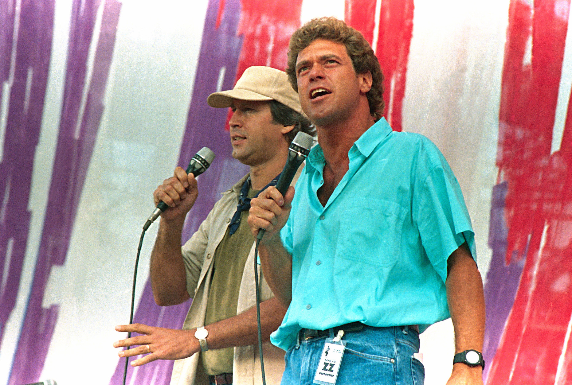 Former Saturday Night Live television show members Chevy Chase, left, and Joe Piscopo, entertain the crowd during the Live Aid famine relief concert at JFK Stadium in Philadelphia Pa., July 13,1985. (AP Photo/Amy Sancetta)