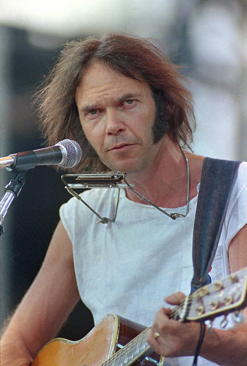 Canadian singer-songwriter Neil Young, playing a Martin acoustic guitar, performs during the Live Aid concert for famine relief at JFK Stadium in Philadelphia, Pa. July 13, 1985.(AP Photo/George Widman)