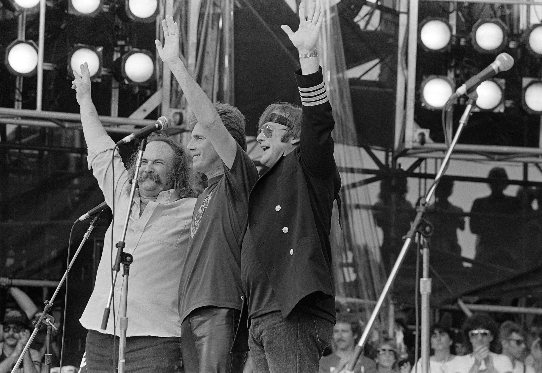 David Crosby, Graham Nash and Stephen Stills wave to the crowd during their Live Aid famine relief concert performance at JFK Stadium in Philadelphia, Pa. July 13, 1985. (AP Photo/Rusty Kennedy)