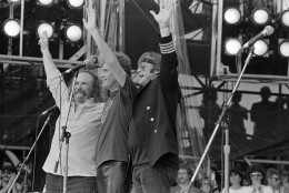David Crosby, Graham Nash and Stephen Stills wave to the crowd during their Live Aid famine relief concert performance at JFK Stadium in Philadelphia, Pa. July 13, 1985. (AP Photo/Rusty Kennedy)