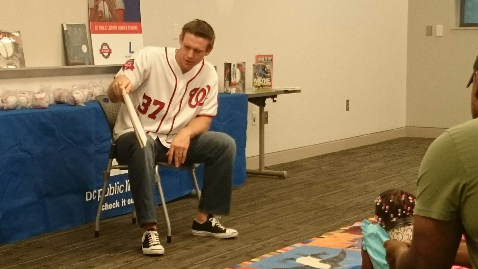 Washington Nationals starting pitcher Stephen Strasburg  reads a story to young fans at the Anacostia Library in Washington, D.C., on Saturday,  July 18, 2015. ( Dennis J. Foley/WTOP)