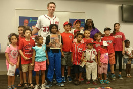 Washington Nationals starting pitcher Stephen Strasburg  poses for a picture with young fans at Anacostia Library in Washington, D.C., on Saturday,  July 18, 2015. ( Dennis J. Foley/WTOP)