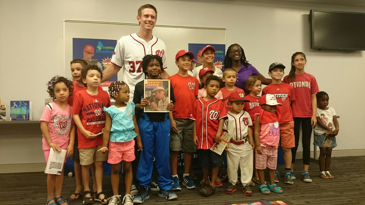 Washington Nationals starting pitcher Stephen Strasburg  poses for a picture with young fans at Anacostia Library in Washington, D.C., on Saturday,  July 18, 2015. ( Dennis J. Foley/WTOP)