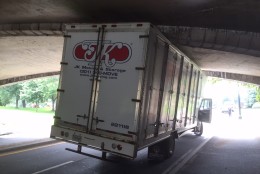 For the second time in a week, an over-height truck became lodged under a low-clearance bridge on the Rock Creek Parkway. (WTOP/Dave Dildine)