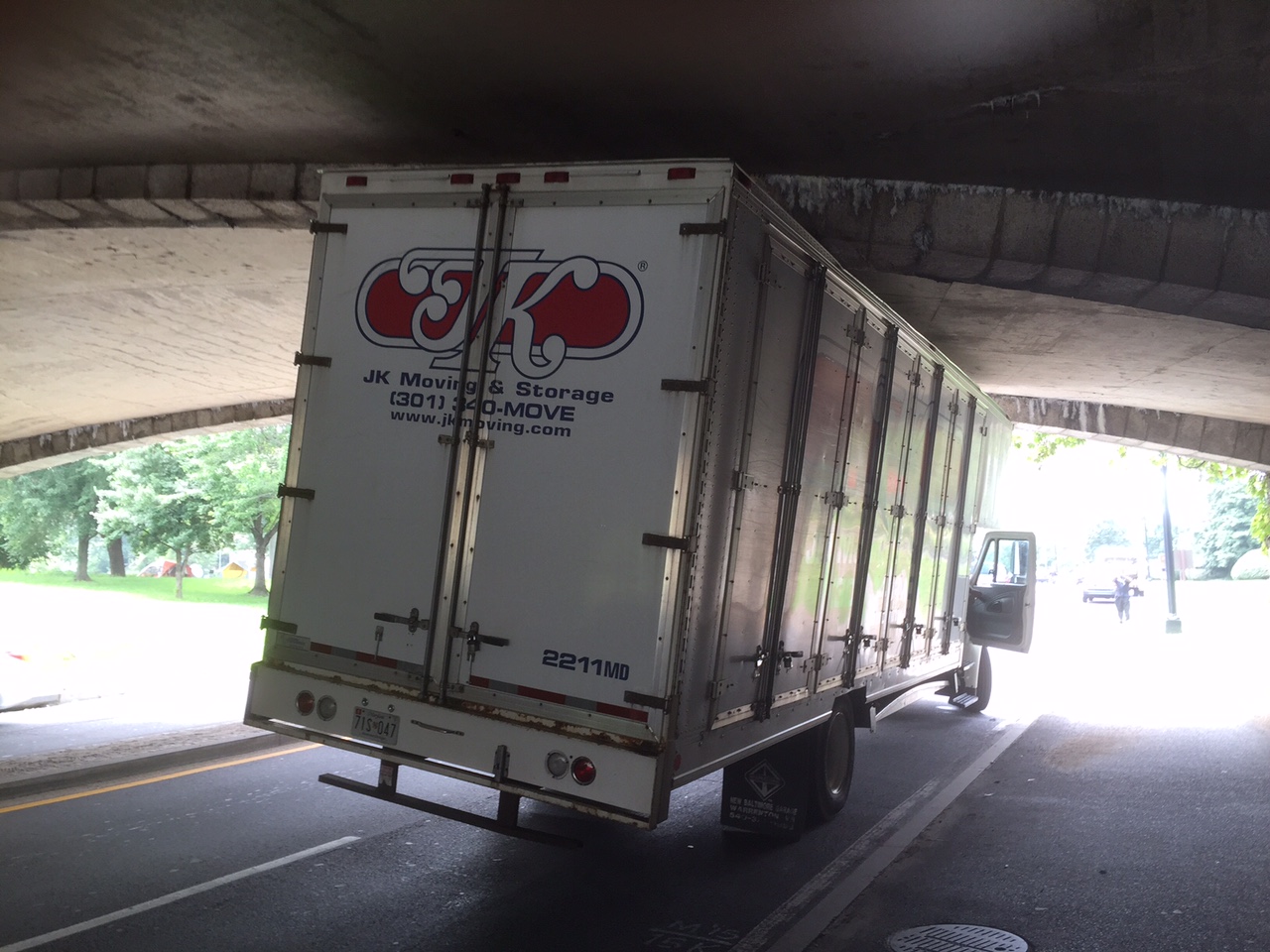 For the second time in a week, an over-height truck became lodged under a low-clearance bridge on the Rock Creek Parkway. (WTOP/Dave Dildine)