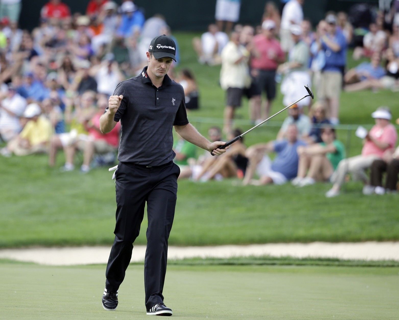 Justin Rose, of England, reacts after making a birdie on the 14th hole during the third round of the Memorial golf tournament Saturday, June 6, 2015, in Dublin, Ohio. (AP Photo/Darron Cummings)