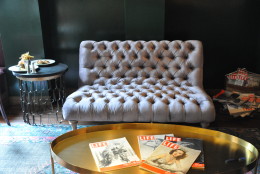 Vintage Life magazines decorate a gold coffee table in the lounge. (WTOP/Rachel Nania)