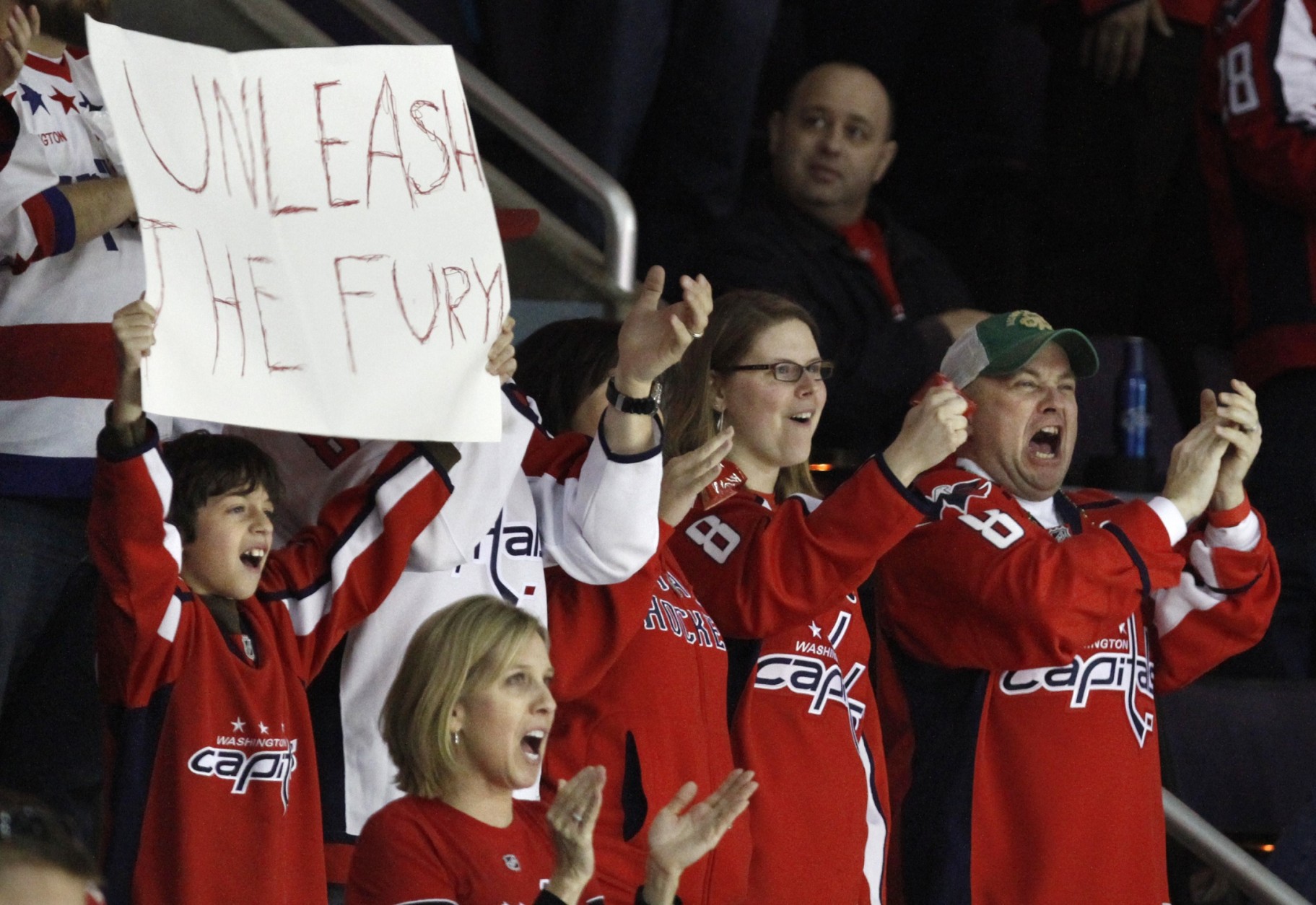 Fans cheer on the Washington Capitals during the third period of an NHL hockey game against the Chicago Blackhawks at the Verizon Center in Washington, on Sunday, March 13, 2011. The Capitals won 4-3 for their eighth straight victory. (AP Photo/Jacquelyn Martin)