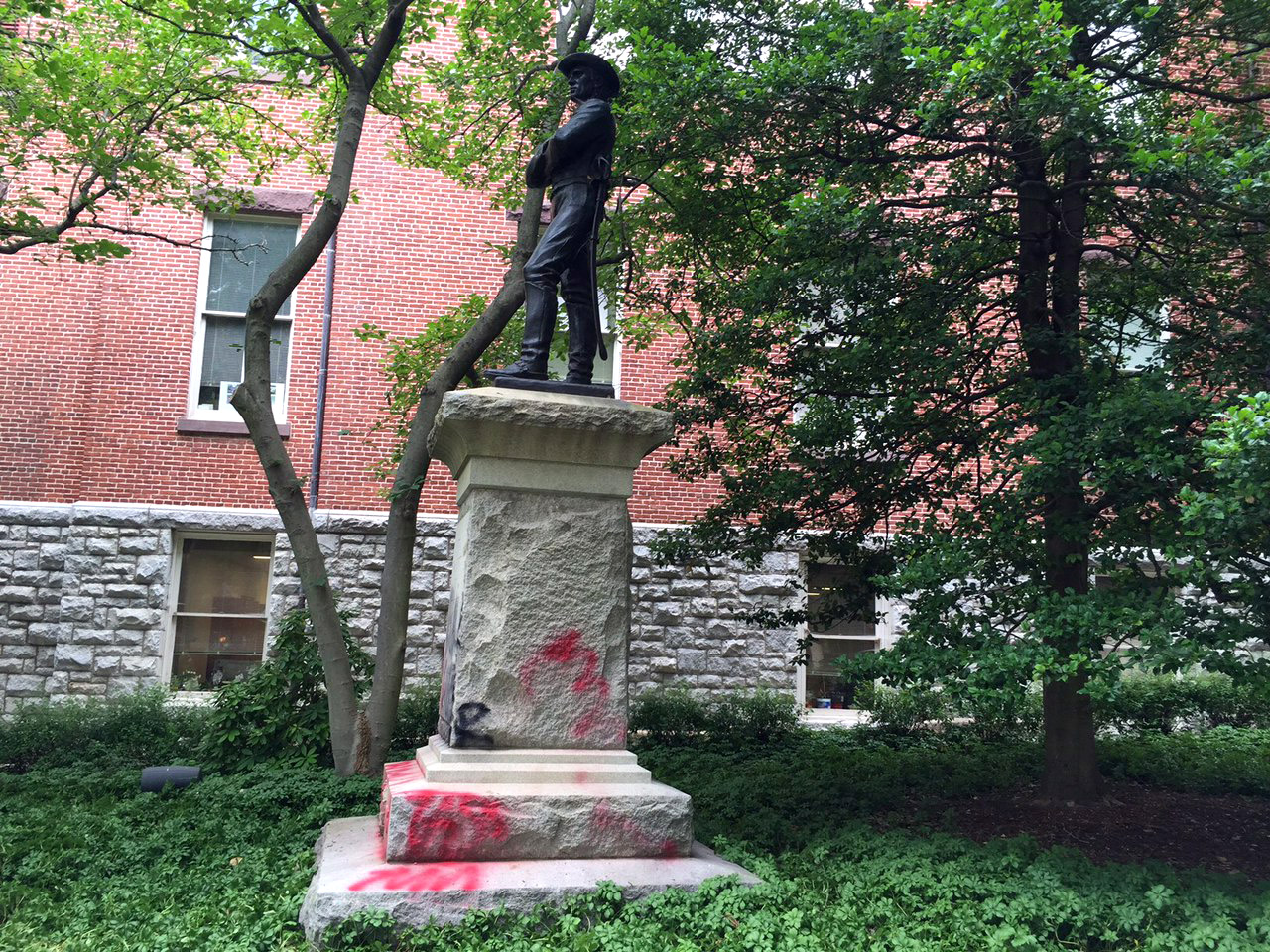 Vandals spray painted a Confederate statues that lies next to the historic Red Brick Courthouse in Rockville. County officials have recently called for the statue to  be moved off county property. (WTOP/Kate Ryan)