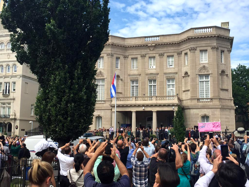 Cellphones grab photos as the Cuban flag is raised outside its embassy in D.C., Monday, July 20, 2015 for the first time in decades. (WTOP/Andrew Mollenbeck)
