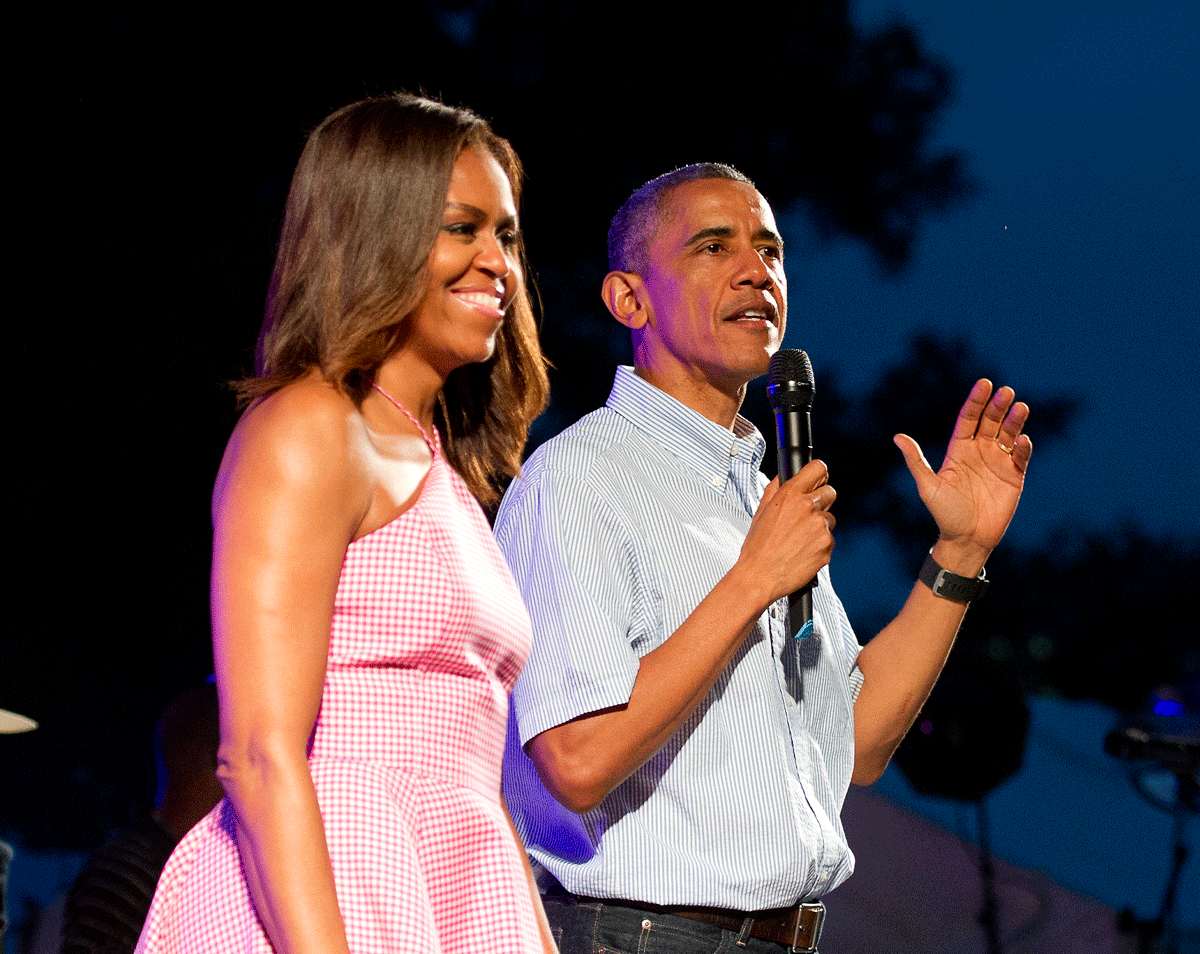 WASHINGTON, DC - JULY 04: U.S. President Barack Obama (R), accompanied by first lady Michelle Obama, gives remarks to members of the military and White House staff who were invited to the South Lawn of the White House on July 4, 2015 in Washington, DC. The guests were treated to a Bruno Mars concert and the traditional fireworks on the National Mall. An earlier Bar-B-Que had been planned but was cancelled due to inclement weather. (Photo by Ron Sachs - Pool/Getty Images)