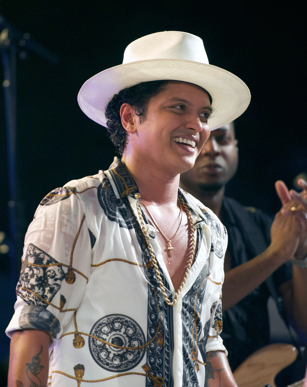 WASHINGTON, DC - JULY 04: Singer Bruno Mars smiles after remarks by U.S. President Barack Obama, accompanied by first lady Michelle Obama, to invited members of the military and White House staff on the South Lawn of the White House on July 4, 2015 in Washington, DC. The guests were treated to a Bruno Mars concert and the traditional fireworks on the National Mall. An earlier Bar-B-Que had been planned but was cancelled due to inclement weather. (Photo by Ron Sachs - Pool/Getty Images)