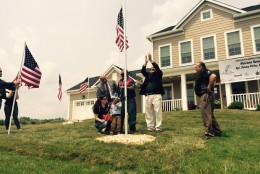 The Porta family raises the flag outside the house. (WTOP/Max Smith)
