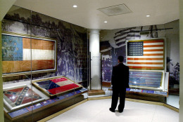 Isaac Leventon looks over historical flags in the Georgia Hall of Valor in the Capitol in Atlanta, Wednesday, Jan. 31, 2001. The flags include the Confederate battle flag, bottom left, and two versions of the Confederate States National Flag-First Pattern, second from left, and top left.  (AP Photo/Ric Feld)