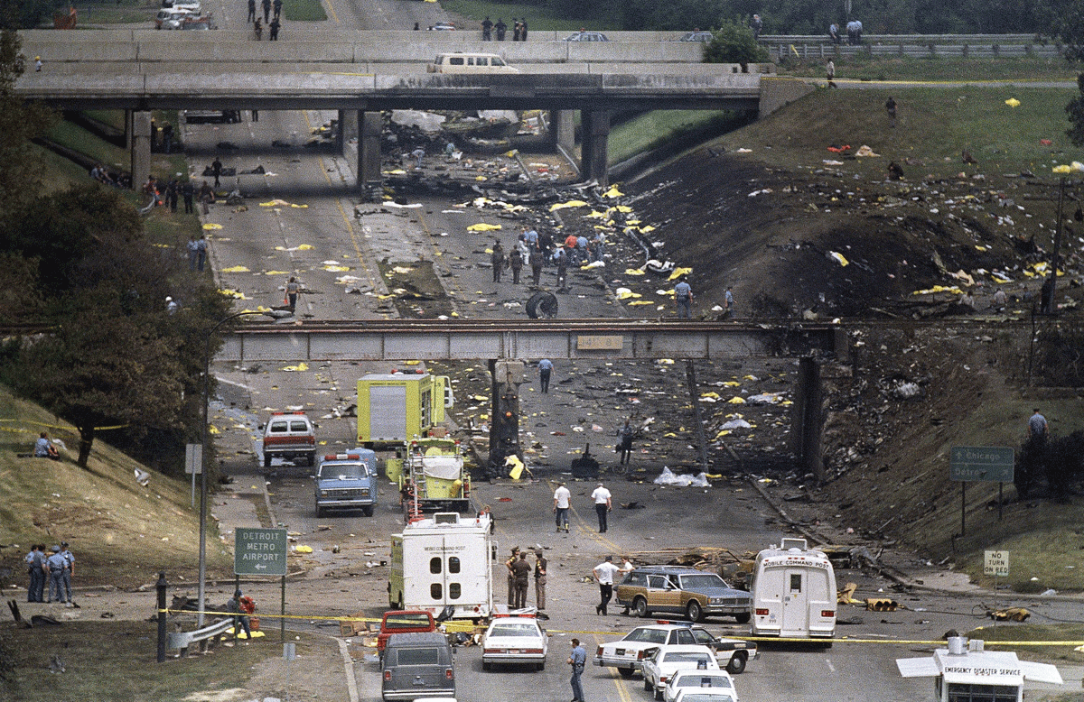 In this Aug. 16, 1987 file photo, bag-covered bodies are strewn across the hillsides flanking Middlebelt Road in Romulus, Mich., after a Northwest Airlines MD-80, bound for Phoenix, crashed shortly after takeoff from Detroit Metropolitan Airport. In the new documentary, “Sole Survivor,” Cecelia Cichan, whose married name is Crocker, at age 4 was the lone survivor of the crash that killed 154 people aboard and two on the ground breaks her silence, discussing how the crash of the Phoenix-bound jetliner has affected her. (AP Photo/Dale Atkins, file)