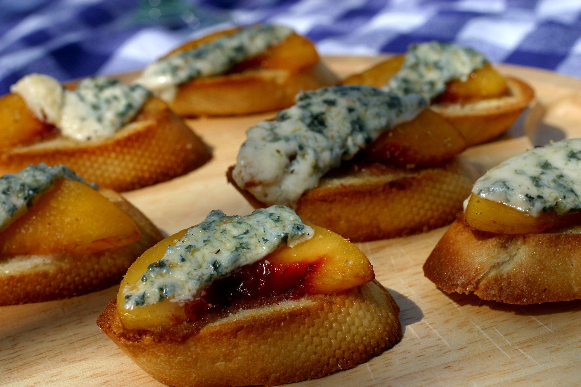 ** FOR USE WITH AP WEEKLY FEATURES **   Crostini With Peaches and Blue Cheese are made with a recipe from "Good Day for a Picnic" by Jeremy Jackson. Although not all the recipes in the cookbook may be suitable for taking out for a picnic meal, this one wins the label of outstanding. The crostini are assertively sweet and tangy and travel well. (AP Photo/Larry Crowe)