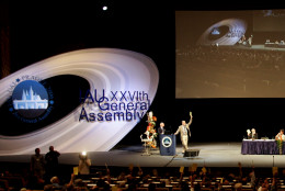 On this date in 2006, the International Astronomical Union declared that Pluto was no longer a planet, demoting it to the status of a "dwarf planet." Here, members of the IAU are seen voting on the issue. (AP Photo/Petr David Josek)