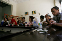 Cuban workers take a coffee break at a snack bar on Obispo street in Old Havana, Monday, June 11, 2007. One of the largest concentrations of venders selling street food for Cuban pesos can be found on Havana's bustling Obispo Street. (AP Photo/Javier Galeano)