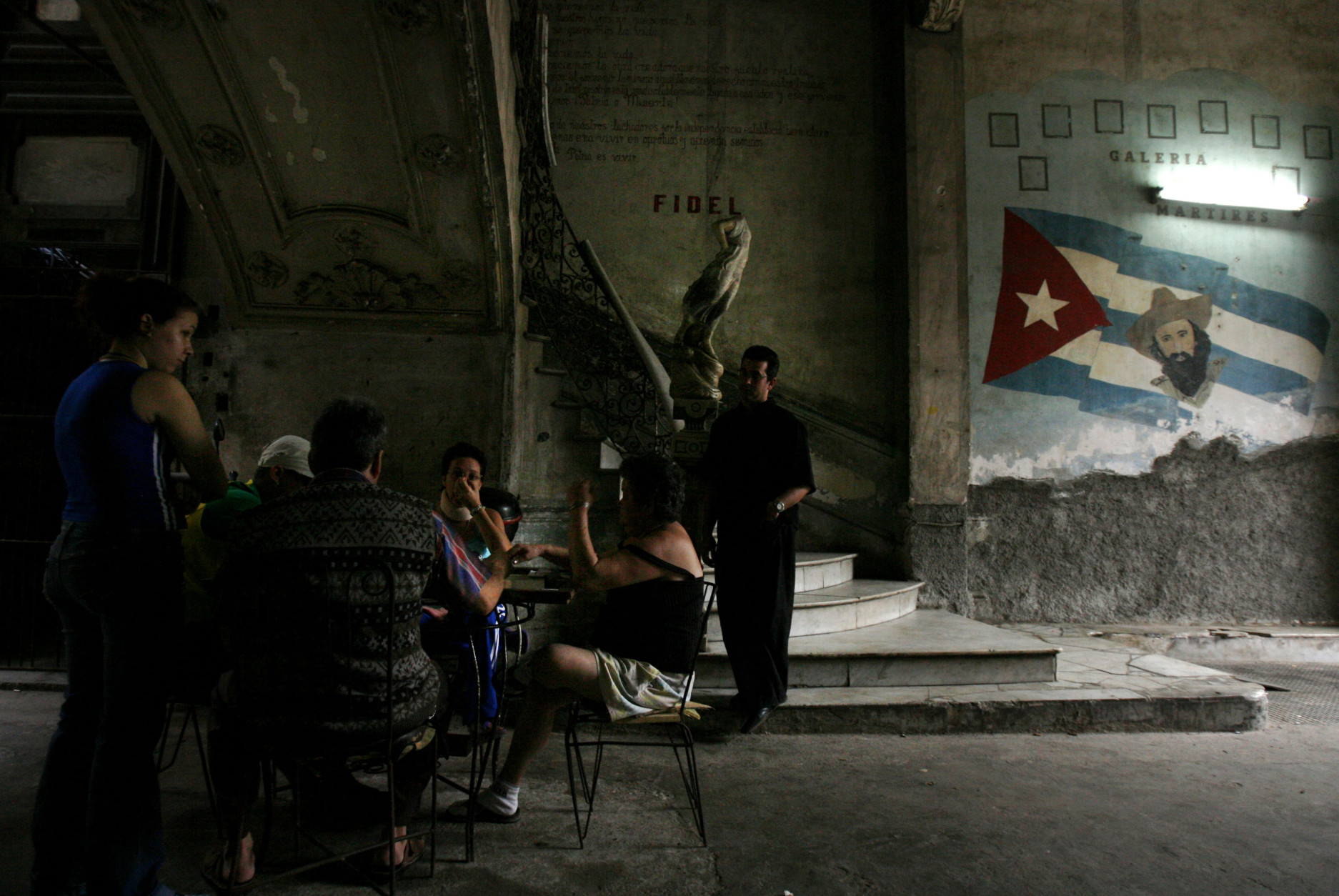 People play dominoes in the entrance of La Guarida, Havana's best known paladar, or private restaurant, in Havana, Monday, March 10, 2008. (AP Photo/Javier Galeano)