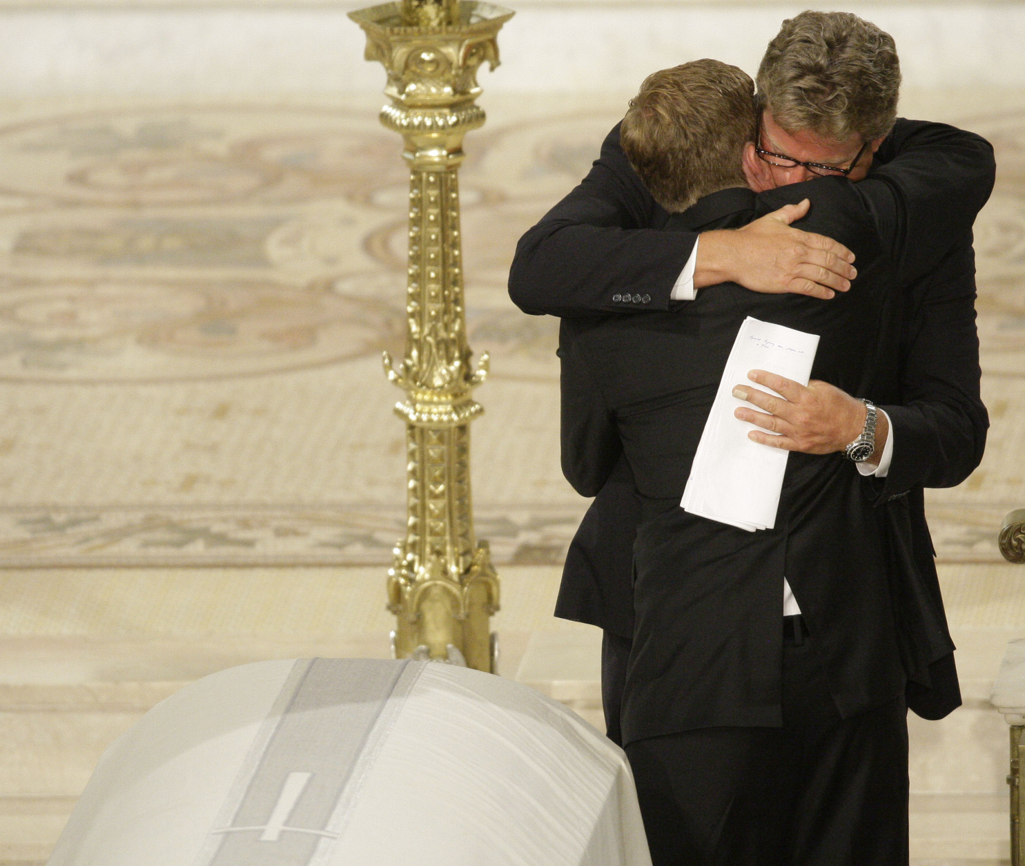 On this date in 2009, Sen. Edward M. Kennedy died at age 77 in Hyannis Port, Massachusetts, after a battle with a brain tumor. Here, Edward Kennedy Jr., hugs his brother Rep. Patrick Kennedy, D-R.I.,at the Roman Catholic Funeral Mass for Sen. Edward M. Kennedy at Our Lady of Perpetual Help Basilica in Boston Saturday, Aug. 29, 2009. (AP Photo/Alex Brandon)
