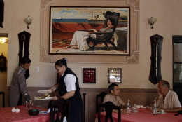 In this photo taken Friday, April 29, 2011, wait staff attend to customers at "La Moneda Cubana," a private restaurant in Old Havana, Cuba. A restaurant boom is sweeping Havana under new rules that make it easier to run "paladars," with a wave of new private eateries opening since January 2011. (AP Photo/Franklin Reyes)